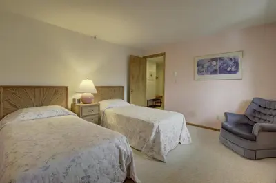 a hotel room with two beds and a chair at 432 Marina Place condo in Dillon