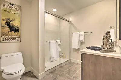 a bathroom with a toilet and a glass shower at Winter Park Condo Proximity to Cafes and Rec Center in Winter Park