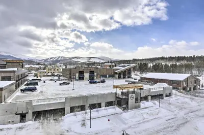 a snow covered city with buildings and cars at Winter Park Condo Proximity to Cafes and Rec Center in Winter Park