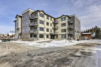 a large apartment building on a snow covered street at Winter Park Condo Proximity to Cafes and Rec Center in Winter Park