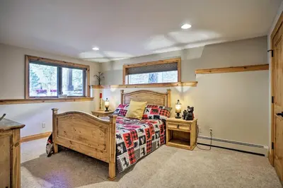 a bedroom with a bed with a wooden frame at Fall River Hideaway in Estes - 3 Mi to Natl Park! in Estes Park