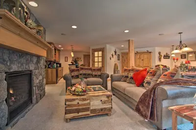 a living room with a couch and a fireplace at Fall River Hideaway in Estes - 3 Mi to Natl Park! in Estes Park