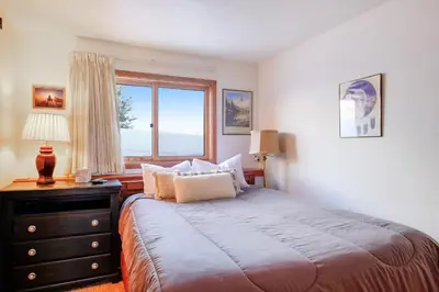 a bedroom with a large bed and a window at Timber Ridge Condo in Silverthorne