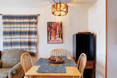 a dining room with a wooden table and chairs at Timber Ridge Condo in Silverthorne