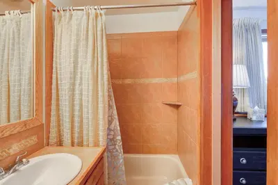 a bathroom with a tub and a sink and a shower at Timber Ridge Condo in Silverthorne