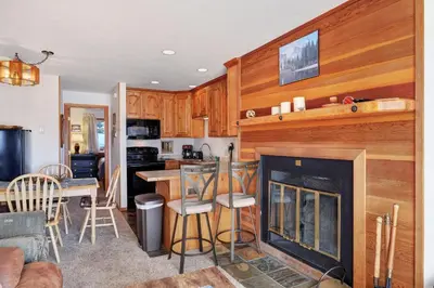 a kitchen and living room with a fireplace at Timber Ridge Condo in Silverthorne