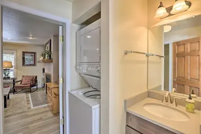 a bathroom with a sink and a washing machine at Walk to Marina Rustic Grand Lake Retreat! in Grand Lake