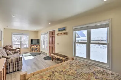 a living room with a couch and a window at Walk to Marina Rustic Grand Lake Retreat! in Grand Lake