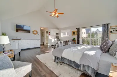 a bedroom with a bed and a large window at Charming Getaway, Walk to Windsor Lake and Downtown! in Windsor