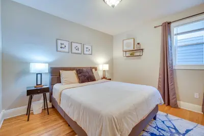 a bedroom with a large bed and a window at Charming Getaway, Walk to Windsor Lake and Downtown! in Windsor
