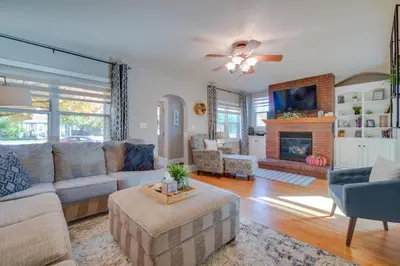 a living room with a couch and a fireplace at Charming Getaway, Walk to Windsor Lake and Downtown! in Windsor