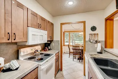 a kitchen with a sink and a stove top oven at Premier 2BR 2BA in Lakeside Village- Kids Ski Free! condo in Keystone