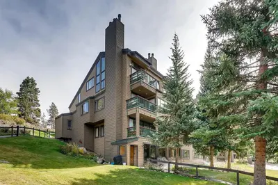 a large house with a tower on top of a hill at Premier 2BR 2BA in Lakeside Village- Kids Ski Free! condo in Keystone