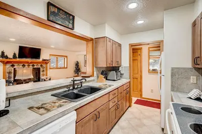 a large kitchen with a sink and a stove at Premier 2BR 2BA in Lakeside Village- Kids Ski Free! condo in Keystone