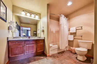 a bathroom with a toilet and a sink and a shower at Zephyr Slopeside - 1504 condo in Winter Park