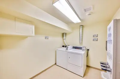 a laundry room with a washer and dryer at Zephyr Slopeside - 1504 condo in Winter Park