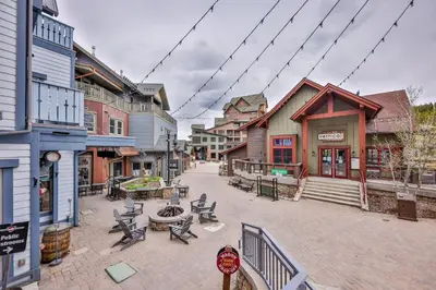 an empty street in a town with benches and buildings at Zephyr Slopeside - 1504 condo in Winter Park