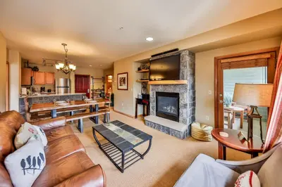 a living room with a couch and a fireplace at Zephyr Slopeside - 1504 condo in Winter Park
