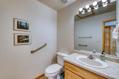 a bathroom with a sink and a toilet and a mirror at Cydney Ln 61C in Silverthorne