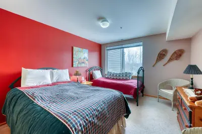a bedroom with red walls and a bed and a window at Cydney Ln 61C in Silverthorne