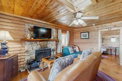a living room with a couch and a fireplace at Grand Lake Cabin Escape in Grand Lake