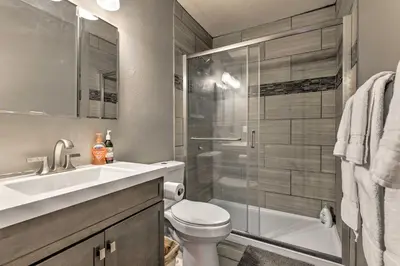 a bathroom with a toilet and a sink and a shower at Cozy Fraser Mtn Retreat with Shuttle to Winter Park in Fraser