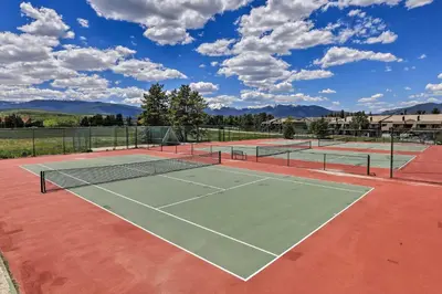 a tennis court with two tennis courts at Cozy Fraser Mtn Retreat with Shuttle to Winter Park in Fraser