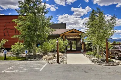 a parking lot in front of a building at Cozy Fraser Mtn Retreat with Shuttle to Winter Park in Fraser
