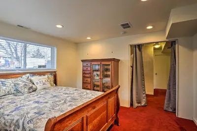 a bedroom with a large bed and a window at Private Yard and Patio Denver Area Home! in Northglenn