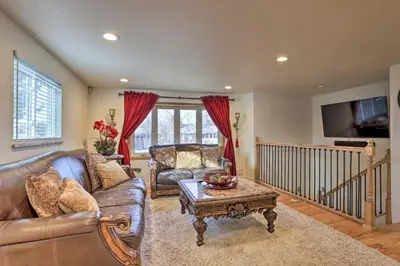 a living room with a leather couch and a coffee table at Private Yard and Patio Denver Area Home! in Northglenn