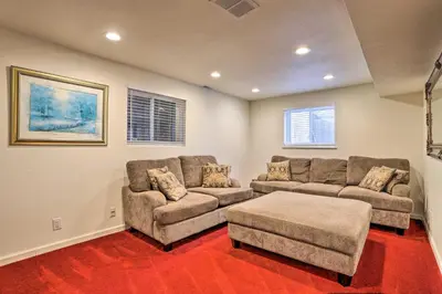 a living room with two couches and a table at Private Yard and Patio Denver Area Home! in Northglenn