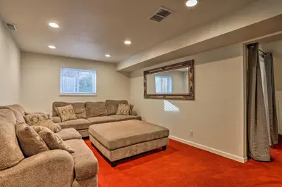 a large living room with a couch and a table at Private Yard and Patio Denver Area Home! in Northglenn