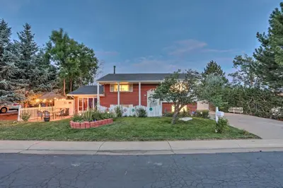 a red house with a porch and a yard at Private Yard and Patio Denver Area Home! in Northglenn