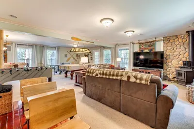 a living room with couches and a pool table at Secluded Log Cabin with Game Room and Forest Views in Red Feather Lakes