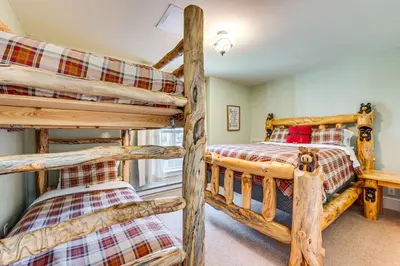 a bedroom with two bunk beds in a lodge at Secluded Log Cabin with Game Room and Forest Views in Red Feather Lakes