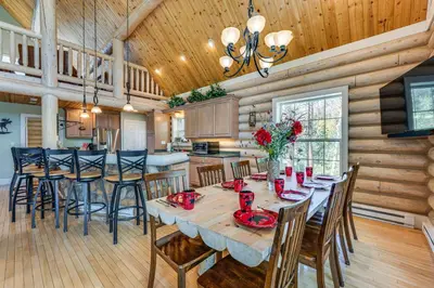 a kitchen and dining room with a table and chairs at Secluded Log Cabin with Game Room and Forest Views in Red Feather Lakes