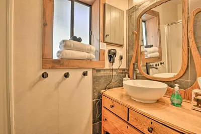 a bathroom with a sink and a mirror at Fireplace, Deck and Mtn Views Grand Lake Home! in Grand Lake