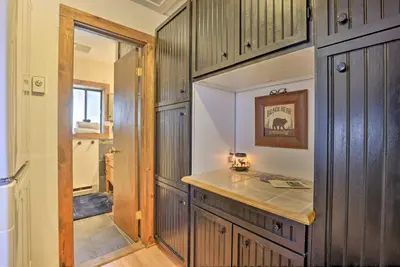 a kitchen with wooden cabinets and a counter top at Fireplace, Deck and Mtn Views Grand Lake Home! in Grand Lake