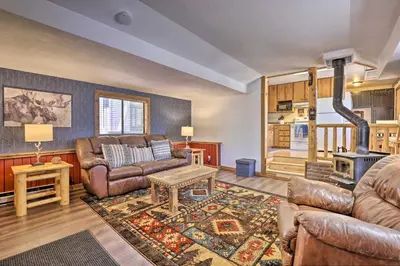 a living room with leather furniture and a fireplace at Fireplace, Deck and Mtn Views Grand Lake Home! in Grand Lake