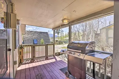 a grill on a screened in porch with a house at Fireplace, Deck and Mtn Views Grand Lake Home! in Grand Lake