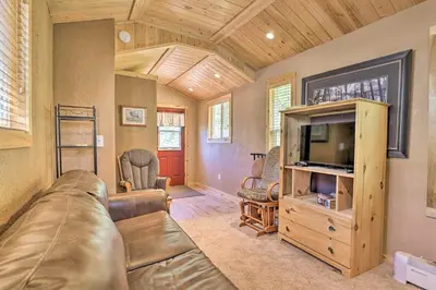 a living room with a couch and a tv at Fireplace, Deck and Mtn Views Grand Lake Home! in Grand Lake