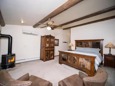 a bedroom with a bed and a fireplace at Taharaa Mountain Lodge in Estes Park