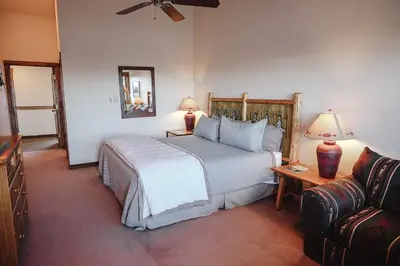 a bedroom with a large bed and a couch at Taharaa Mountain Lodge in Estes Park
