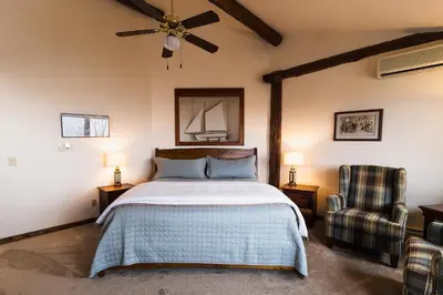a bedroom with a bed and a ceiling fan at Taharaa Mountain Lodge in Estes Park