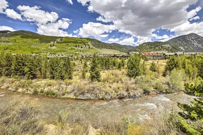 a river in the middle of a field with trees at Walk to Village Condo with Resort Perks in Keystone in Keystone
