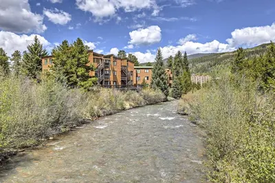 a dirt road in front of a large building at Walk to Village Condo with Resort Perks in Keystone in Keystone
