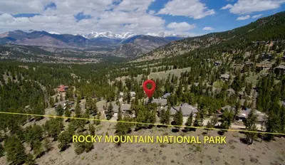 a red balloon is flying over a mountain park at Primavista Luxury Home at Windcliff condo in Estes Park