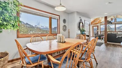 a dining room with a table and chairs at Primavista Luxury Home at Windcliff condo in Estes Park