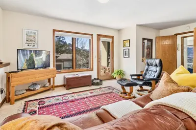 a living room with a couch and a television at Primavista Luxury Home at Windcliff condo in Estes Park
