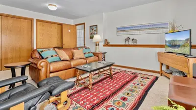 a living room with a couch and a tv at Primavista Luxury Home at Windcliff condo in Estes Park